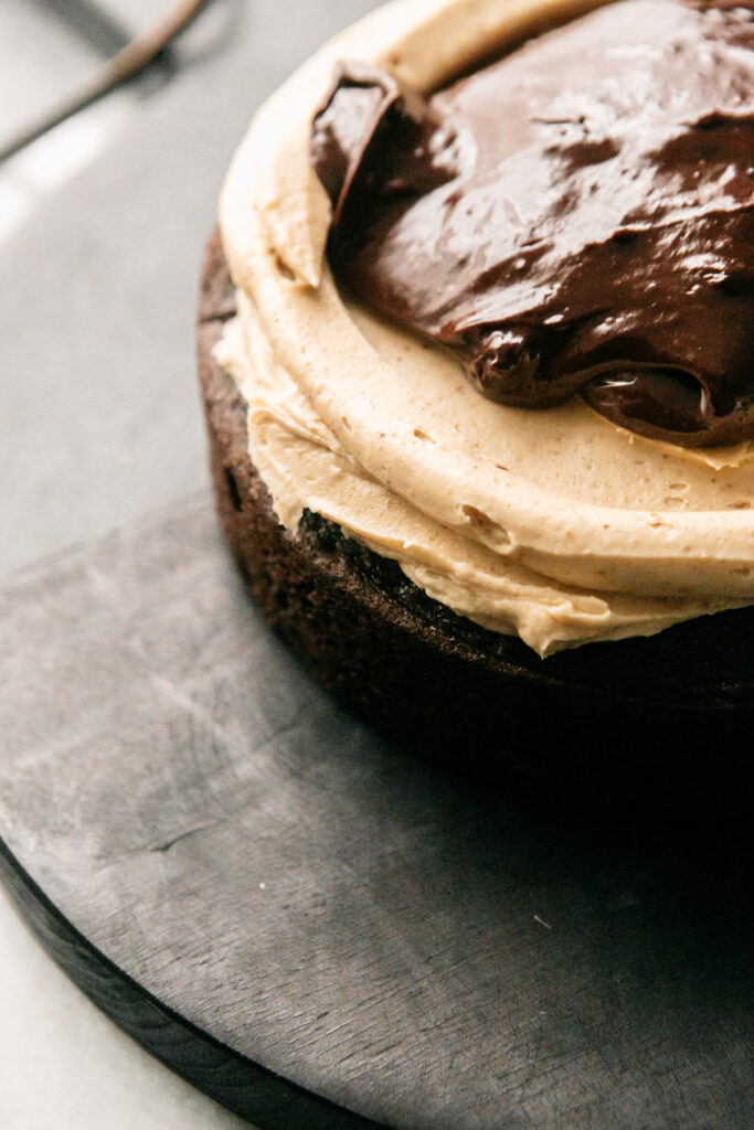 Frosting on a later of cake with ganache 