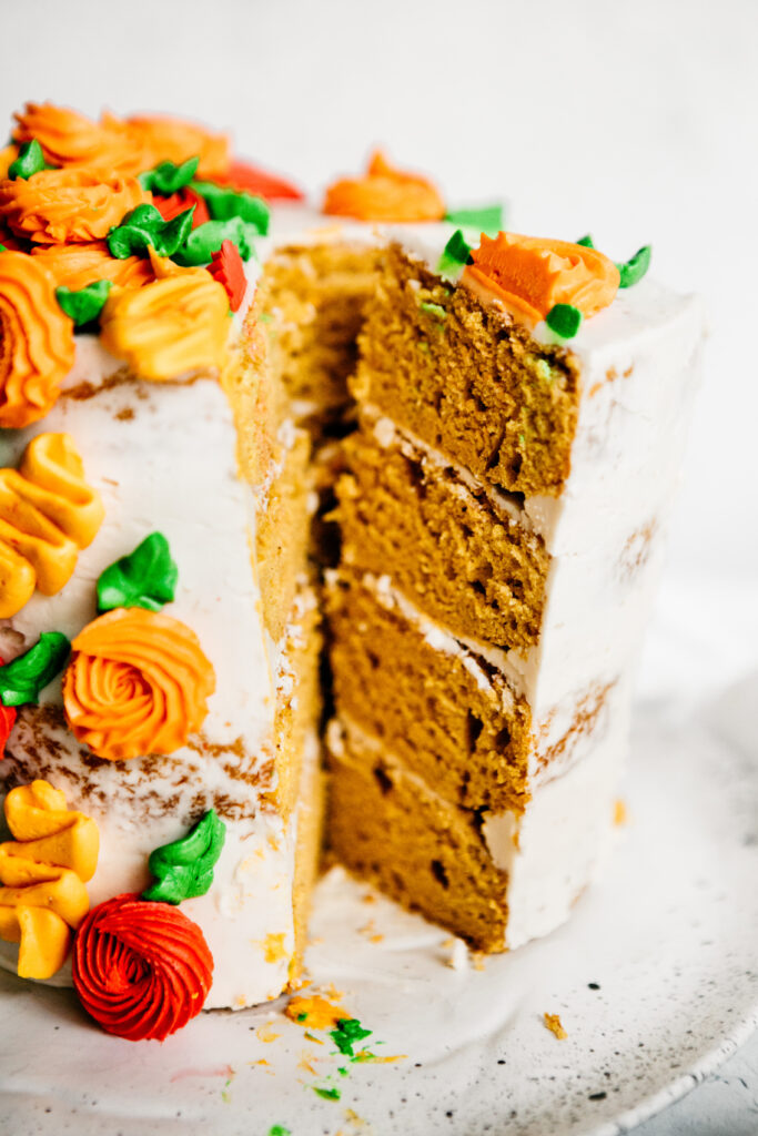 cutting into floral buttercream cake