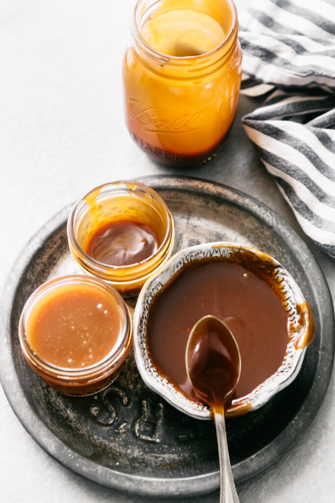 A jar and bowls of caramel  