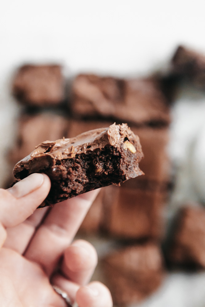 bite out of chocolate frosted fudge brownie