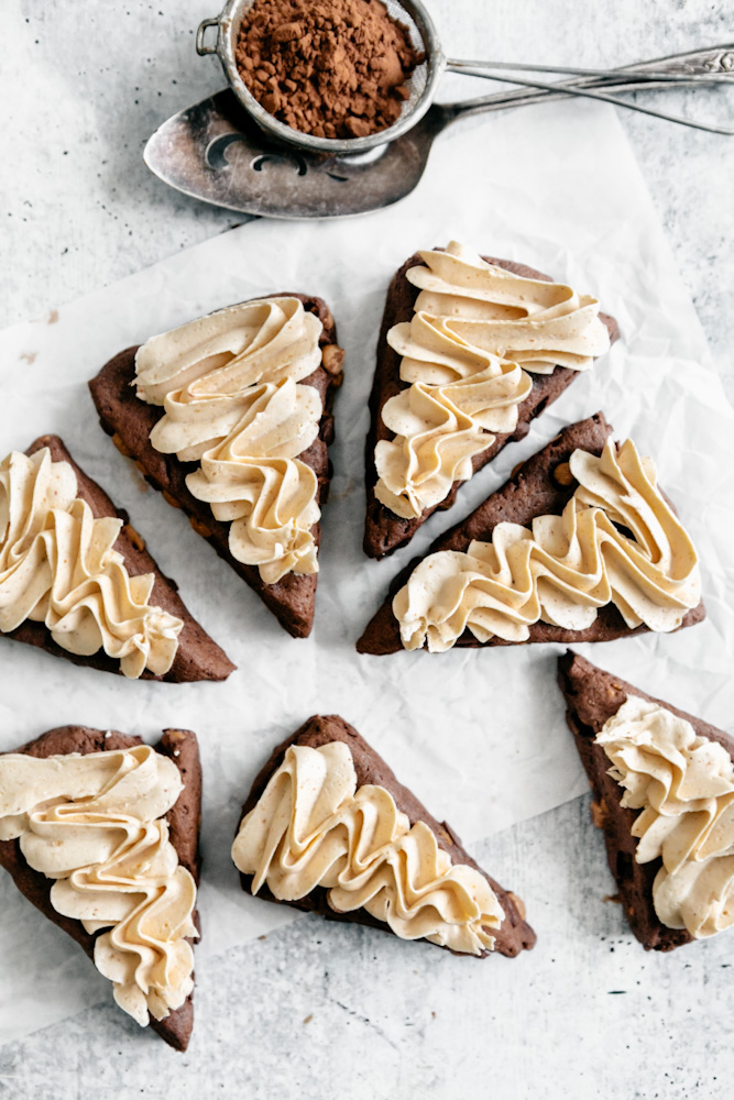 Top down view of peanut butter buttercream frosted scones. 