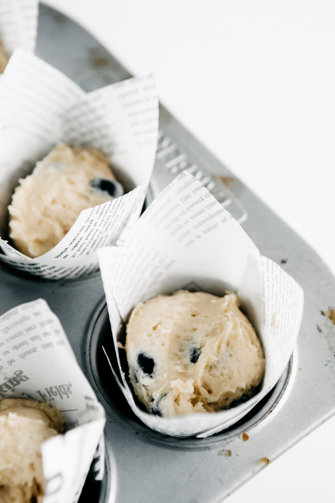 Muffin batter in a muffin tin. 