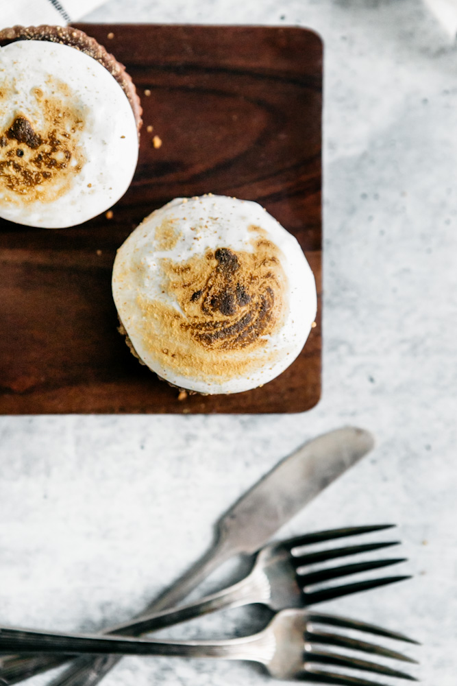 Toasted marshmallow fluff topped s’mores mini cheesecakes. 
