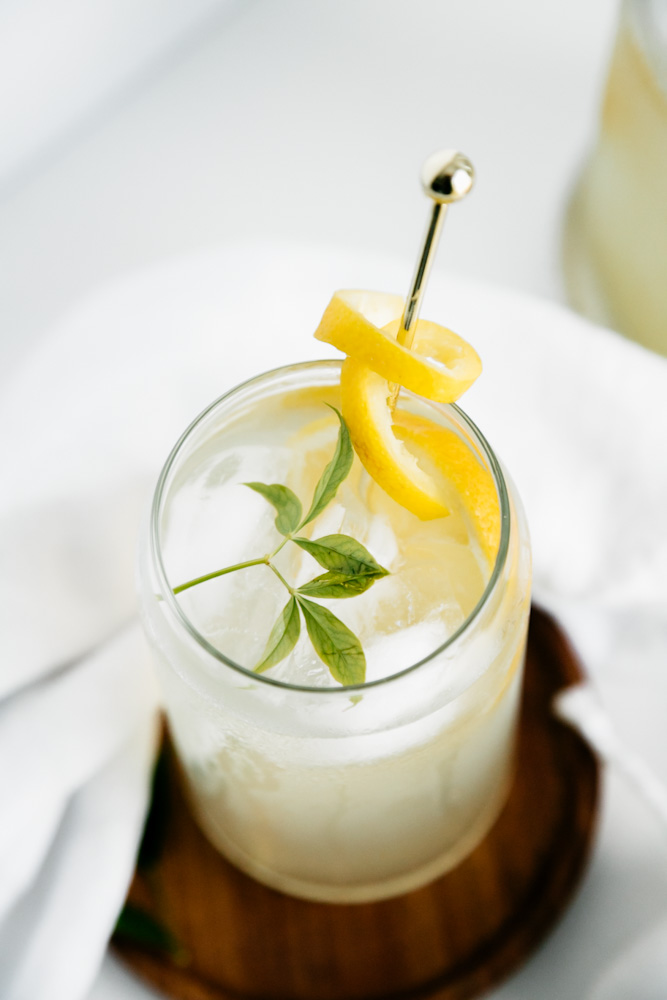 Glass of lemonade with lemon rind twist. 