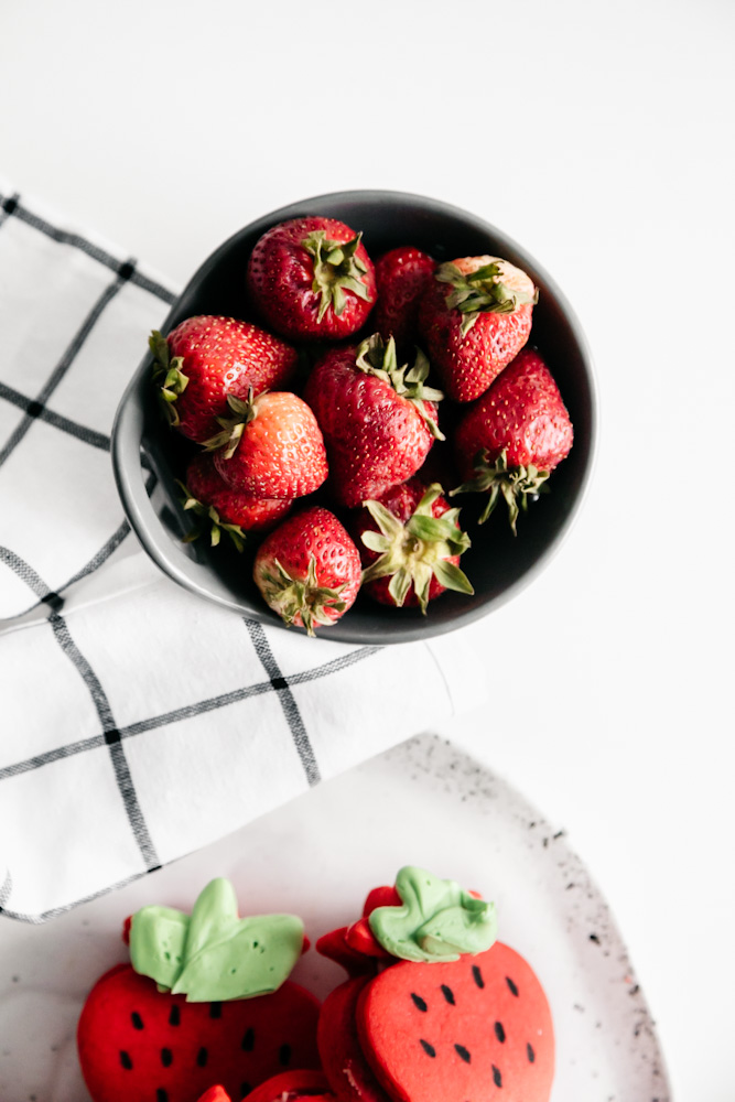 Strawberries in a small grey dish. 