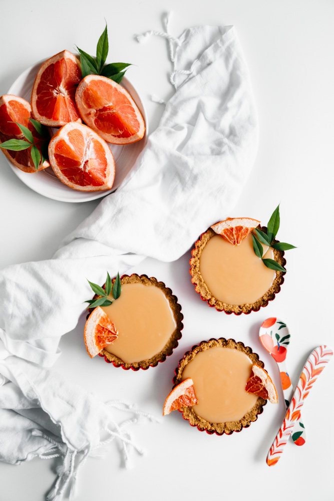 Aerial shot of creamy grapefruit curd mini tarts. 