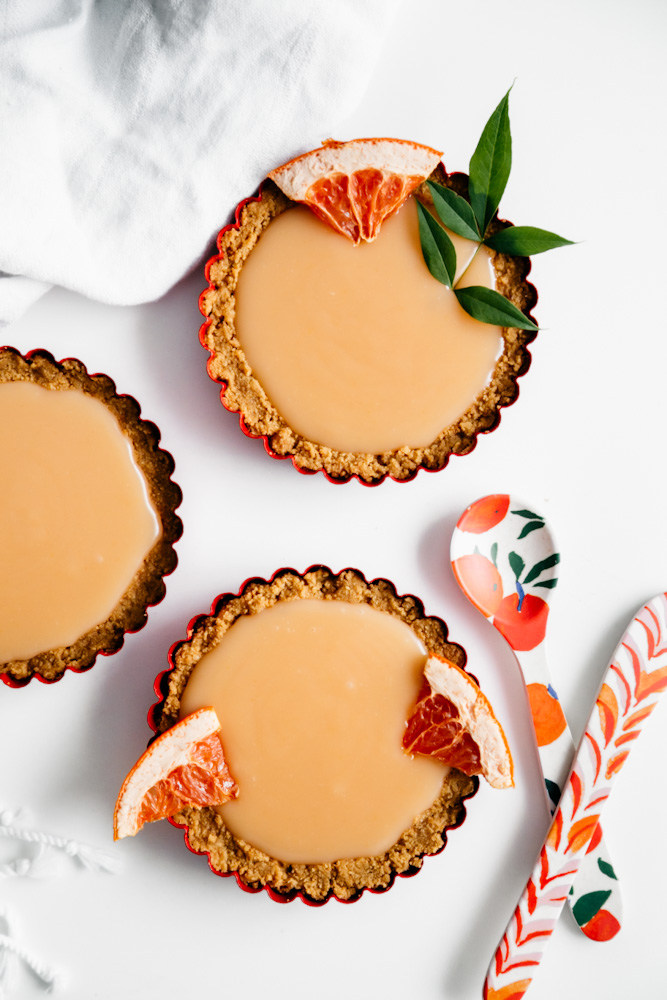 Three creamy grapefruit curd mini tarts . 