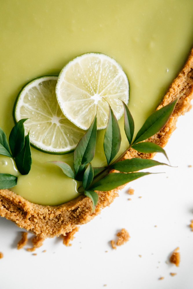 Bottom close up of a deep-dish lime curd tart. 