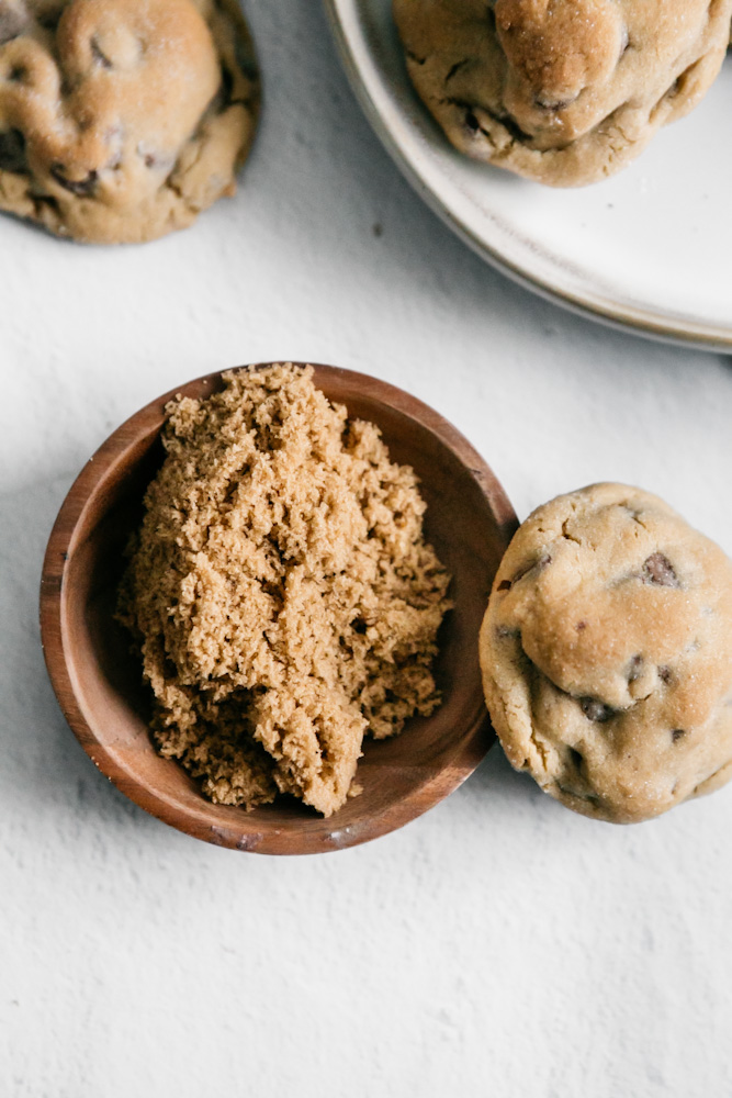 Brown sugar and a cookie resting on the bowl. 