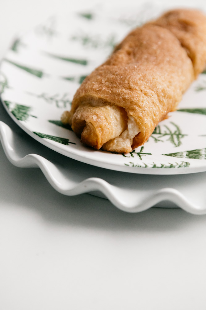 A Sopapilla Cheesecake Roll on a plate 