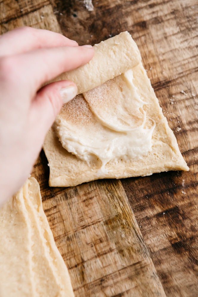 Rolling up Sopapilla Cheesecake Rolls