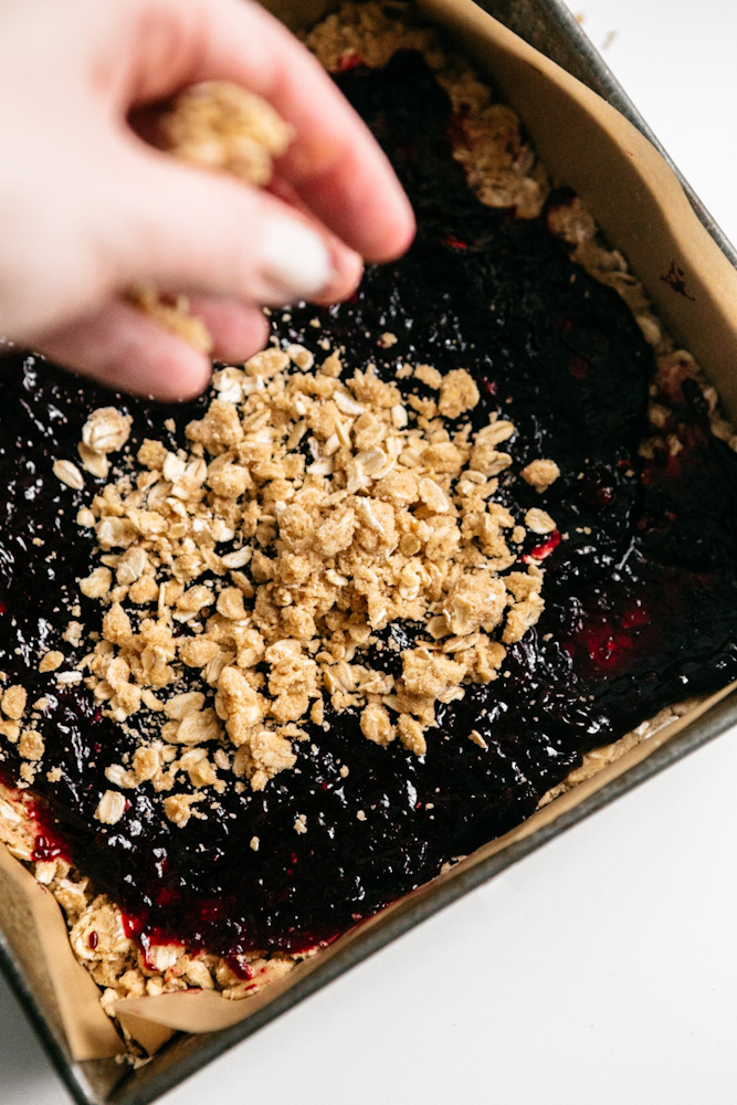 Crumbling topping over blueberry oat bars 