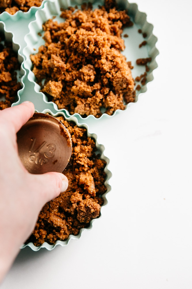 Pressing crust into tins 