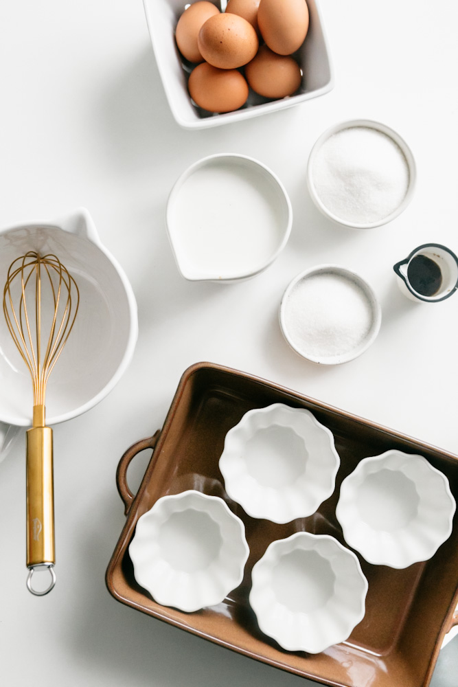 Ingredients and baking dishes on a white table 