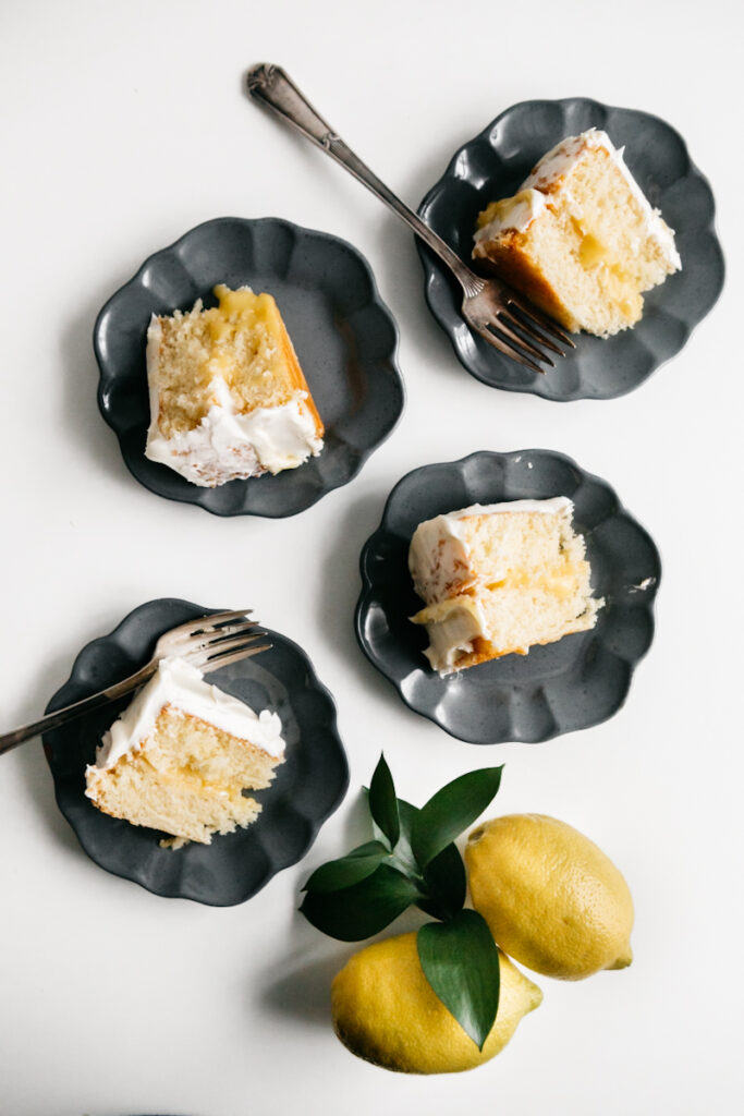 Slices of lemon cake on grey plates 