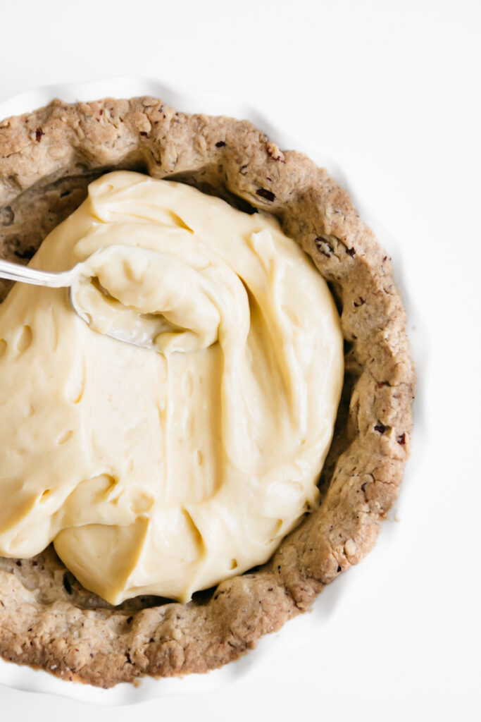 Filling pie crust with butter pecan pudding 