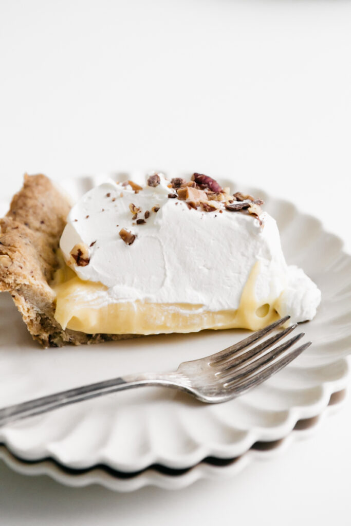 A spice of butter pecan pie with whipped cream 