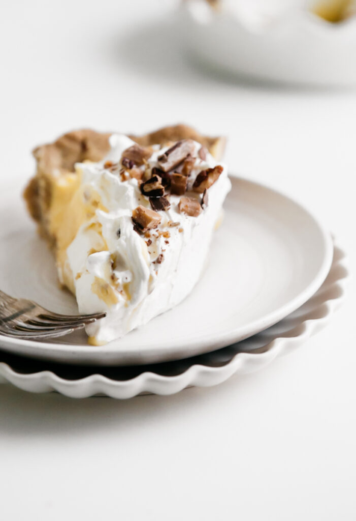 A slice of pie on a white dish 