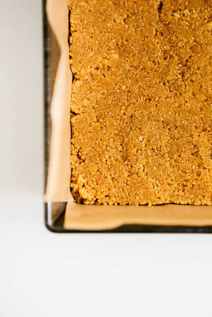 A graham cracker crust in a pan 