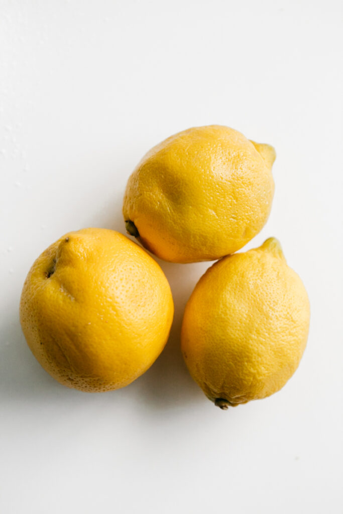 Three lemons on a white table 