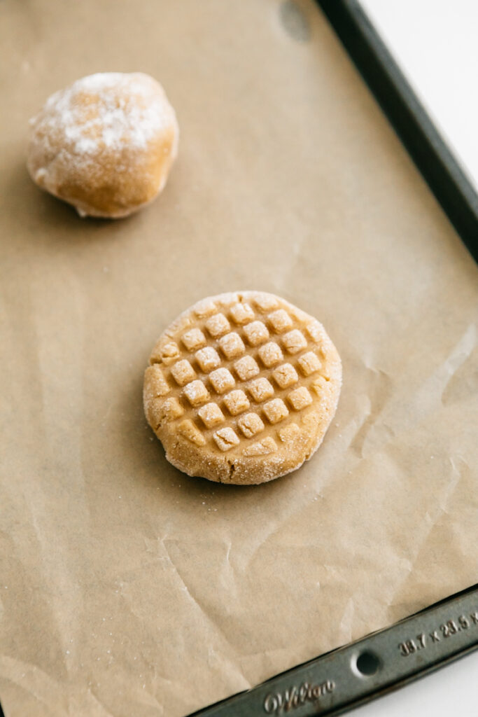 Two Peanut Butter Cookies unbaked on a sheet 