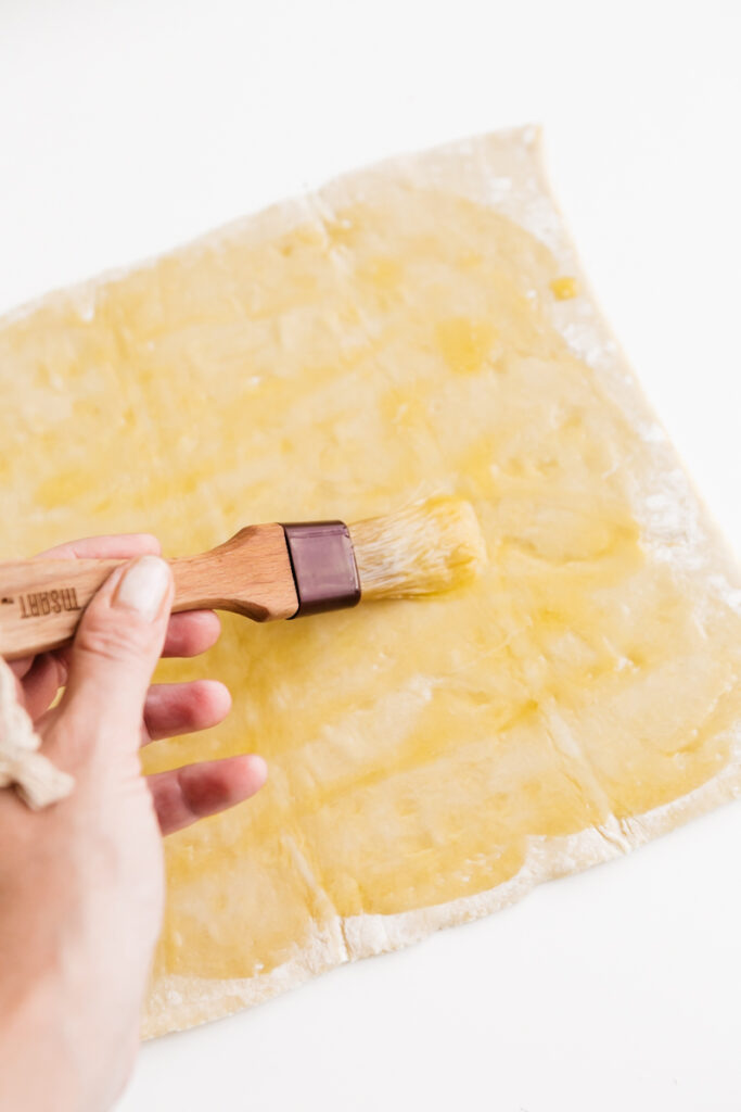 Buttering pastry dough 