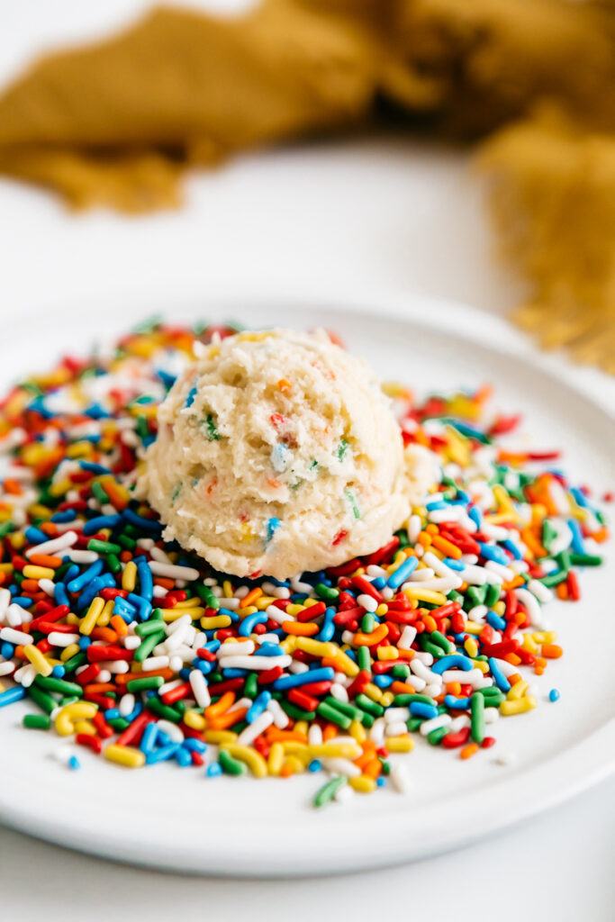 A cookie dough ball in rainbow sprinkles 