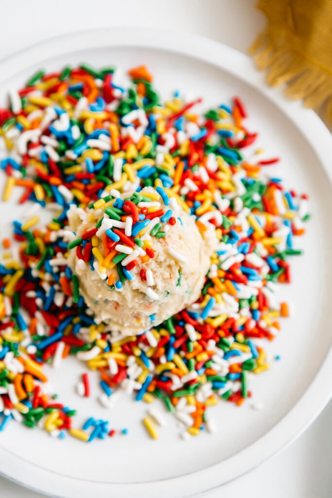 A cookie dough ball in sprinkles 