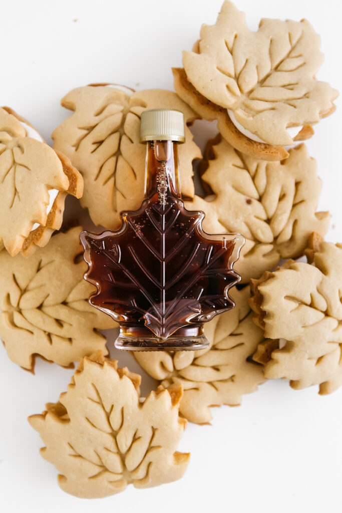 Leaf maple syrup bottle on top of cookies 