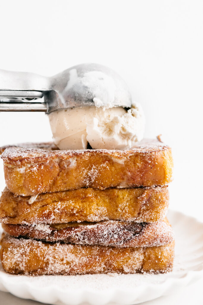 Ice cream scooped onto a stack of French toast 