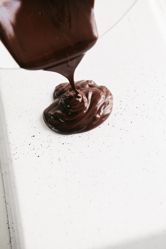 Pouring chocolate onto a pan 