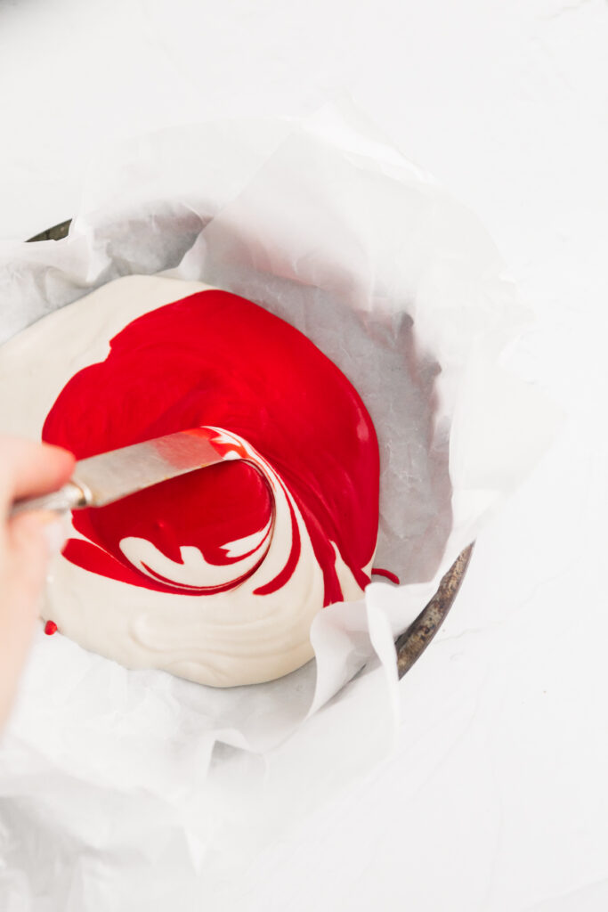 Swirling red and white ice cream in a bowl 