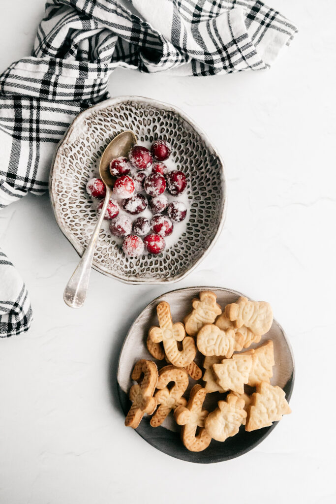 Cranberries and pie crust cookies in bowls 