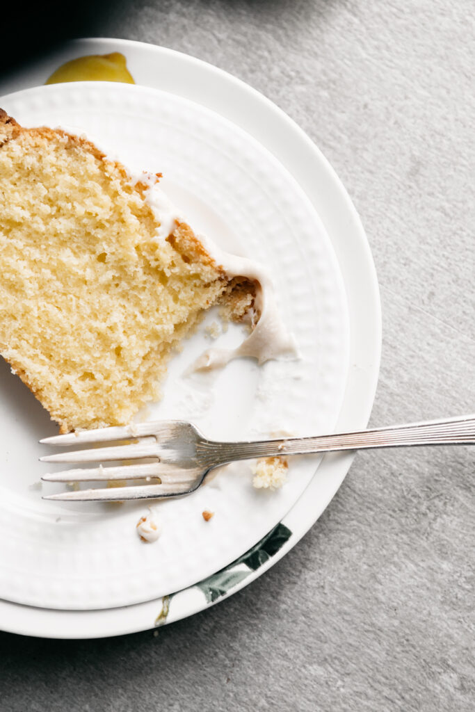 A slice of pound cake on a white plate 