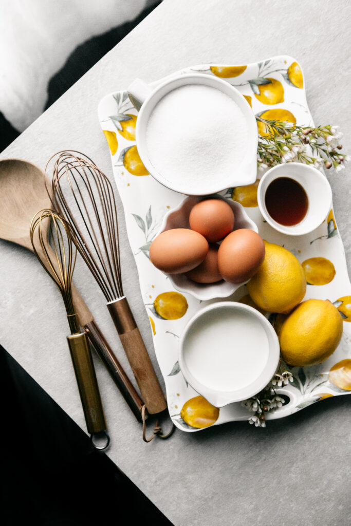 Eggs, lemons, sugar, and milk on a platter 