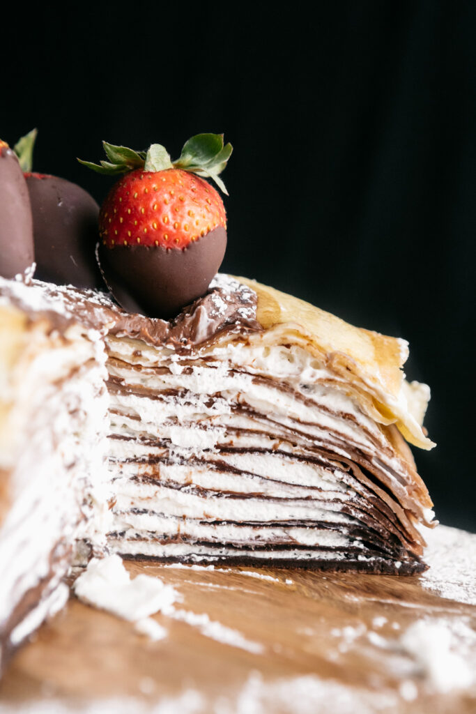 A sliced Chocolate Layered Crepe Cake