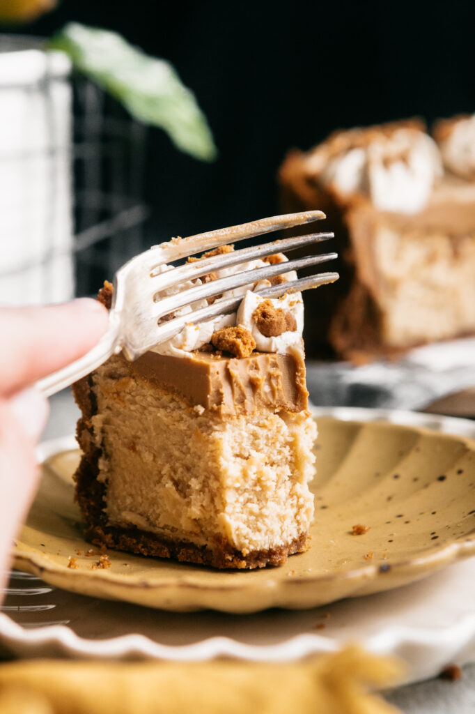 A fork in a slice of cheesecake 