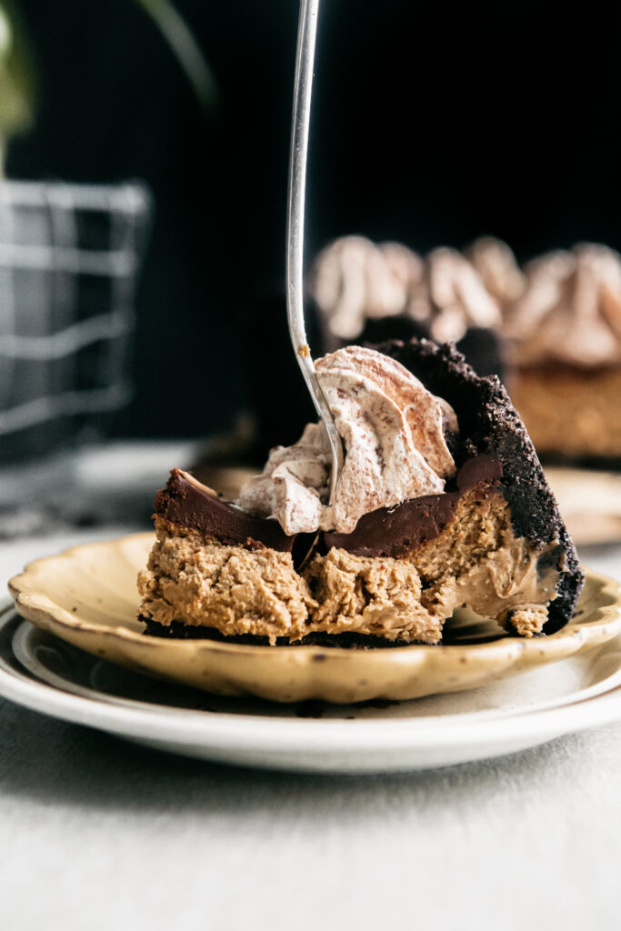 Cutting a slice of cheesecake with a fork 