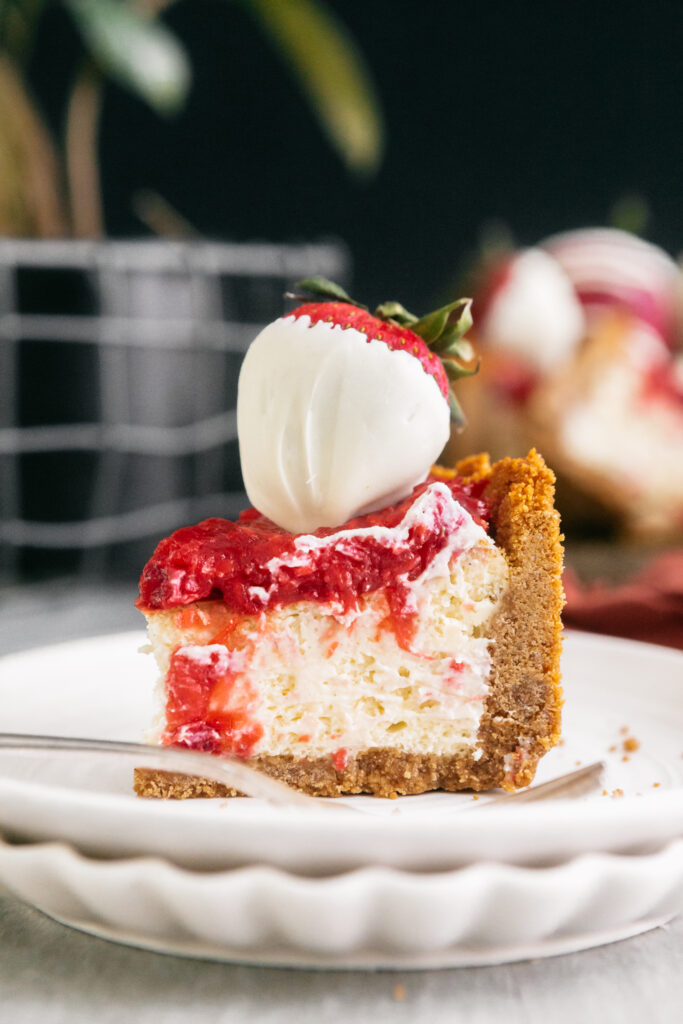 A slice of cheesecake on a white plate 