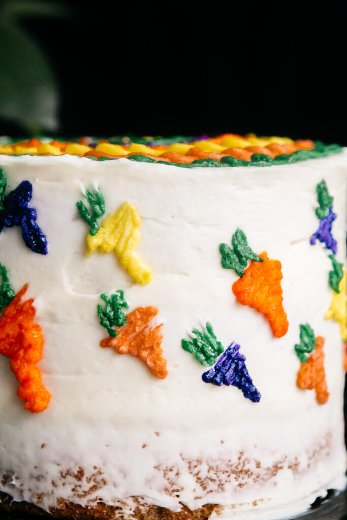 cake with buttercream carrots piped on it 
