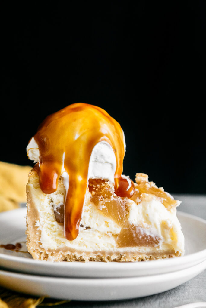 A slice of cheesecake with ice cream and caramel 