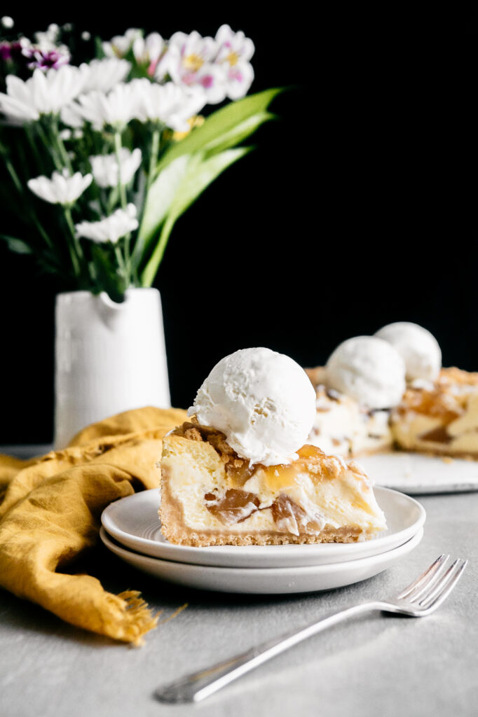 A slice of cheesecake with ice cream 