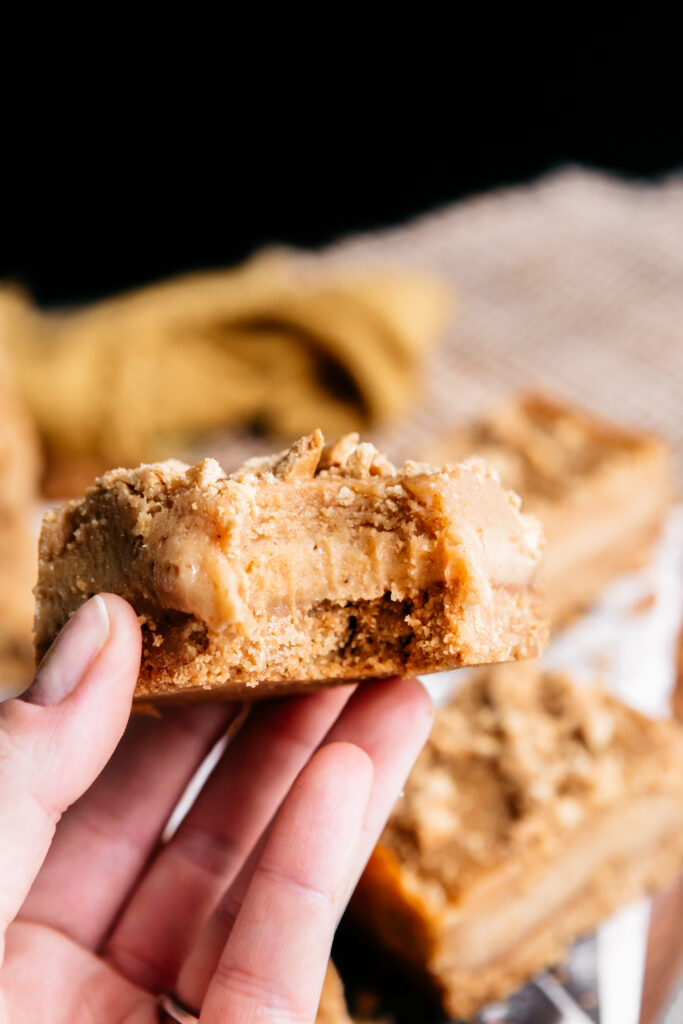 Peanut Butter Cheesecake Bars With a bite out 