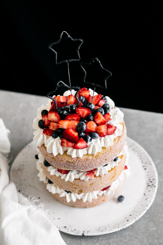 cake with berries and star candles 
