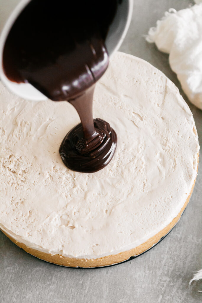 drizzling ganache on a cheesecake 