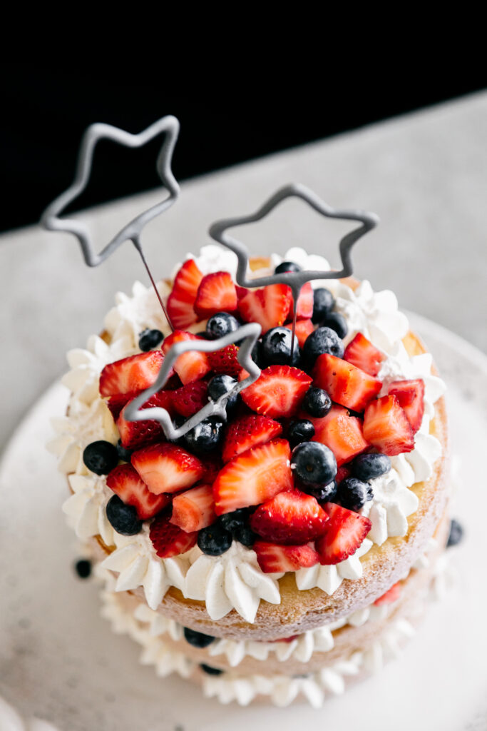 Top view of cake with fruit and candles 