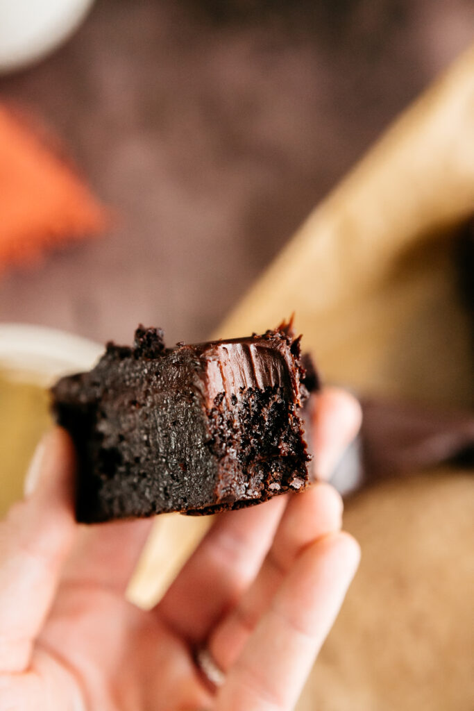 Holding a slice of chocolate cake 