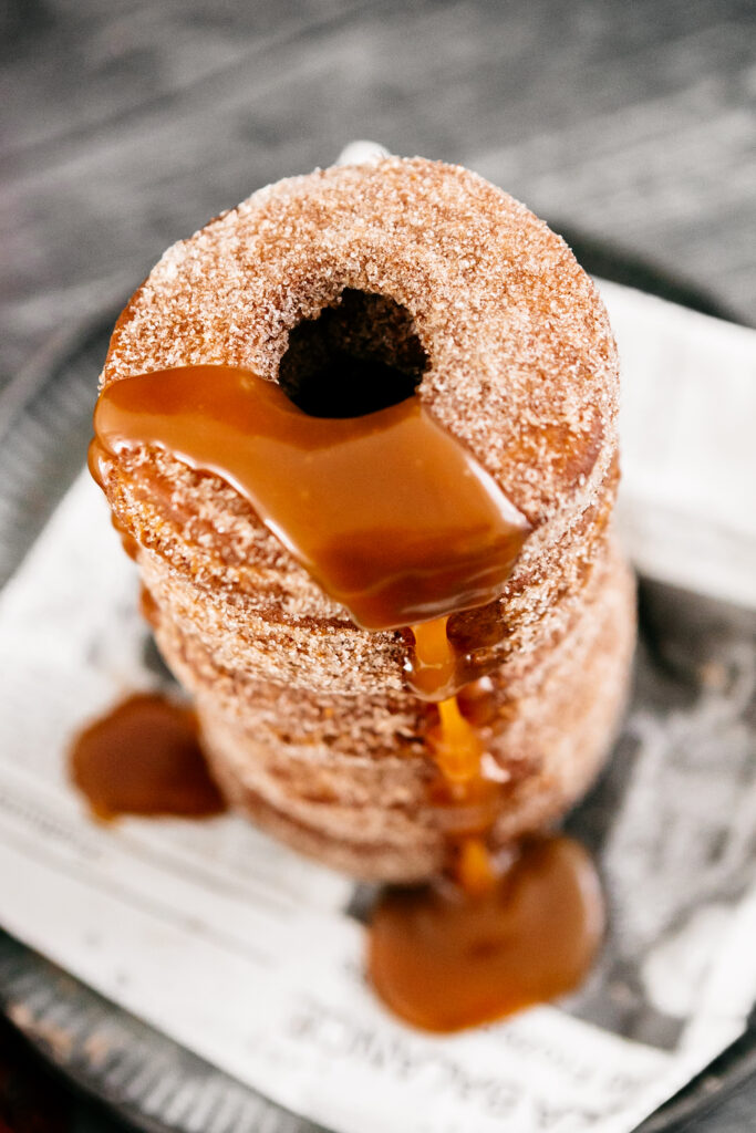 A stack of donuts with caramel sauce 
