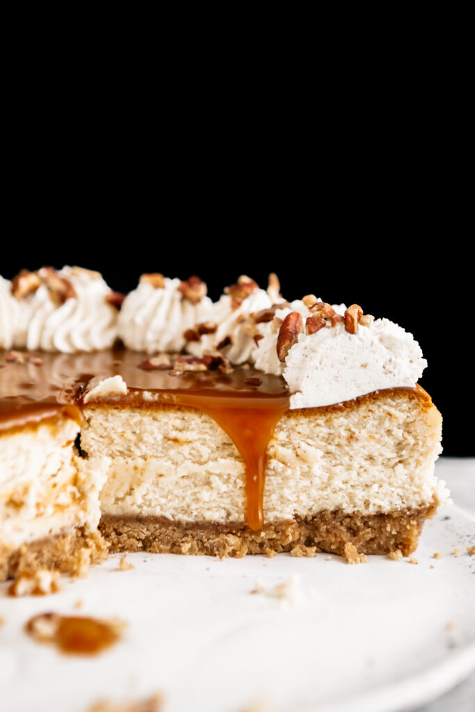Inside of a cheesecake with caramel dripping down 