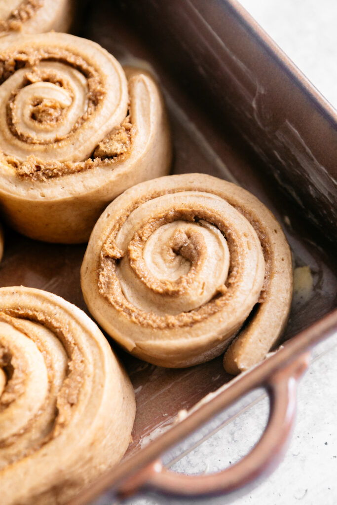 unbaked cinnamon rolls in a dish 